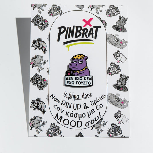Product packaging with 'PINBRAT' branding and cartoon hippo character enamel pin on a white background