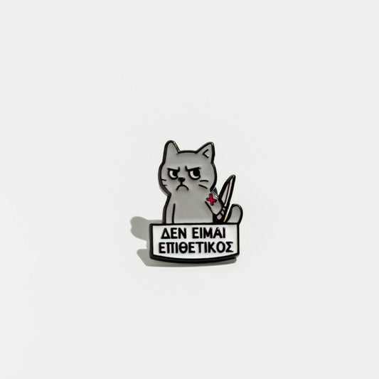 Enamel pin with a cat holding a sign on a white background