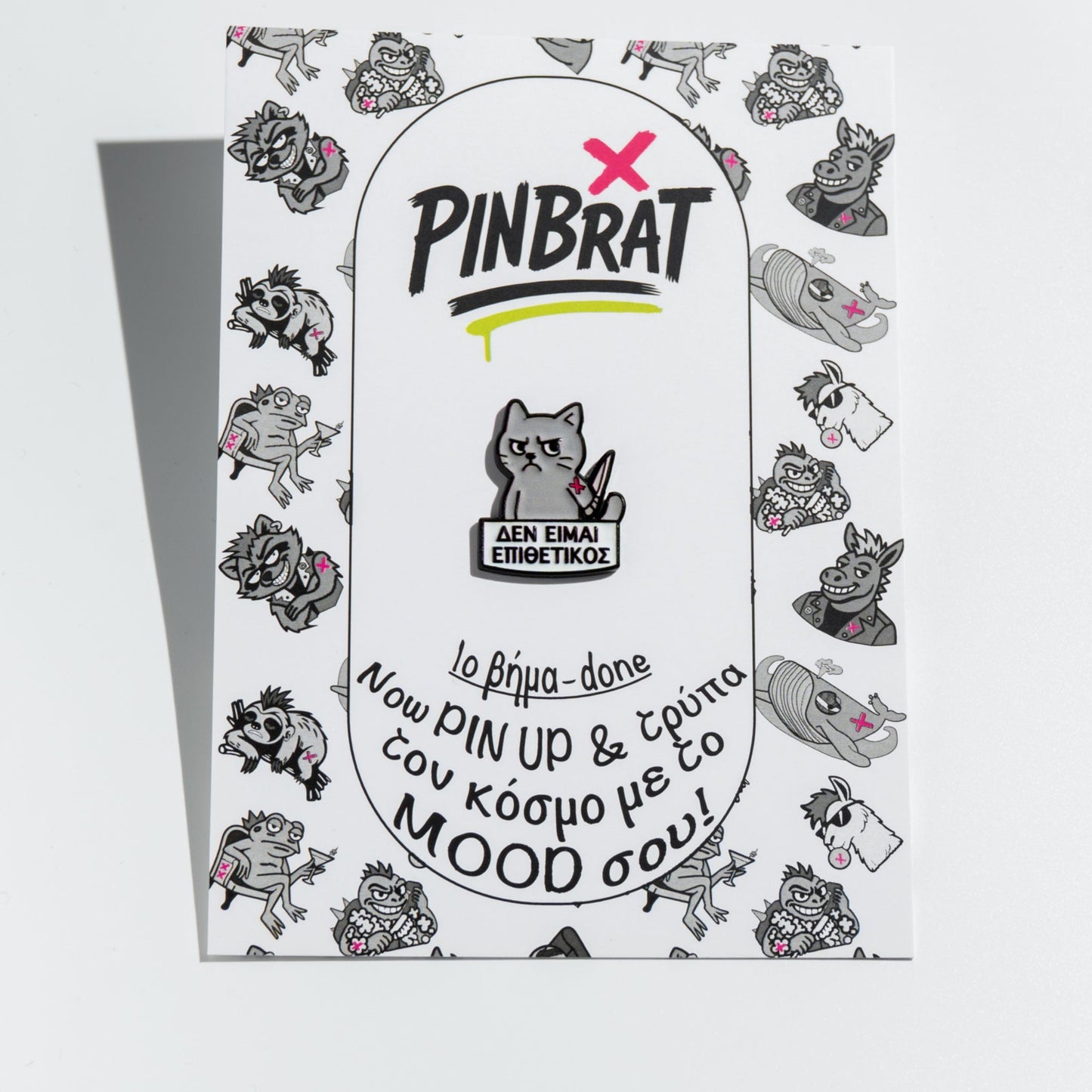 Pinbrat product packaging with cartoon enamel pin cat  on a white background