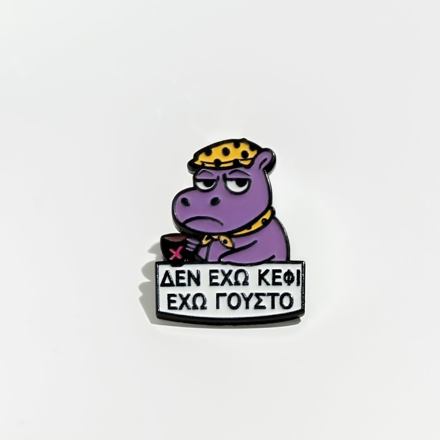 Purple hippo enamel pin cartoon character with a sign on a light gray background