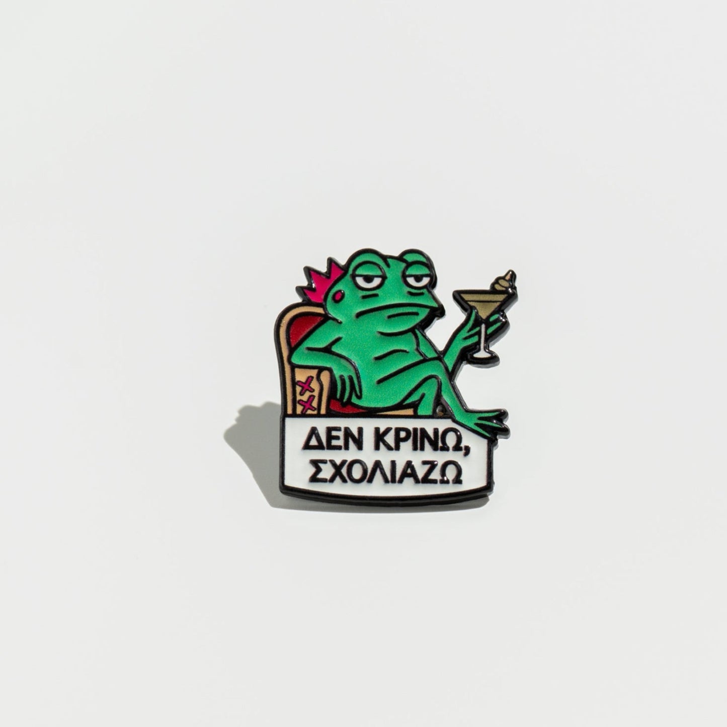 Frog-themed enamel pin with a drink on a white background