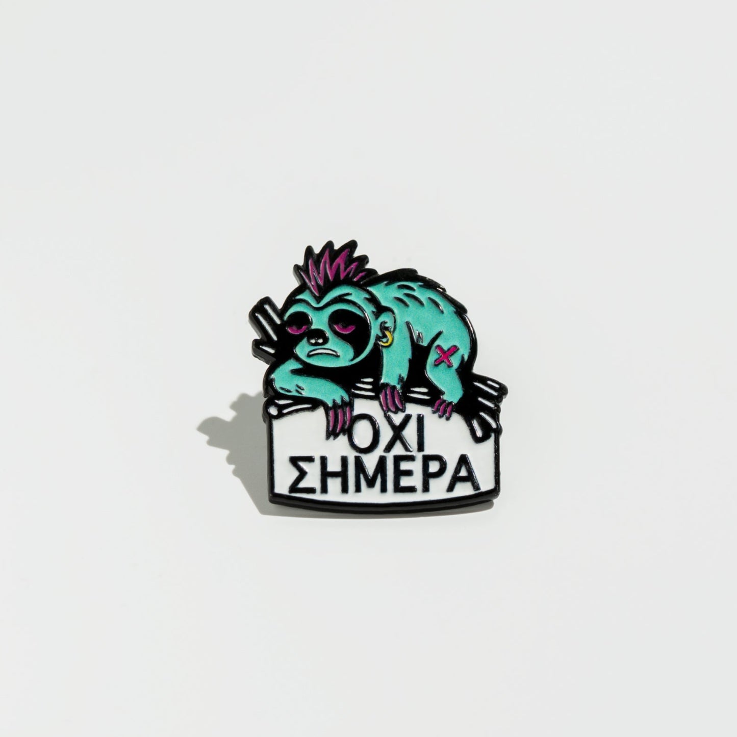 Enamel pin with a stylized sloth holding a sign on a white background