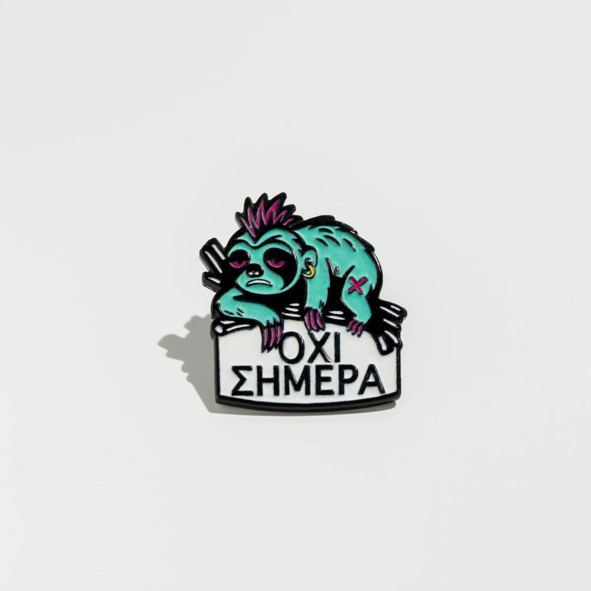 Enamel pin with a stylized sloth holding a sign on a white background