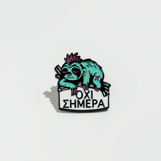 Enamel pin with a stylized sloth holding a sign on a white background