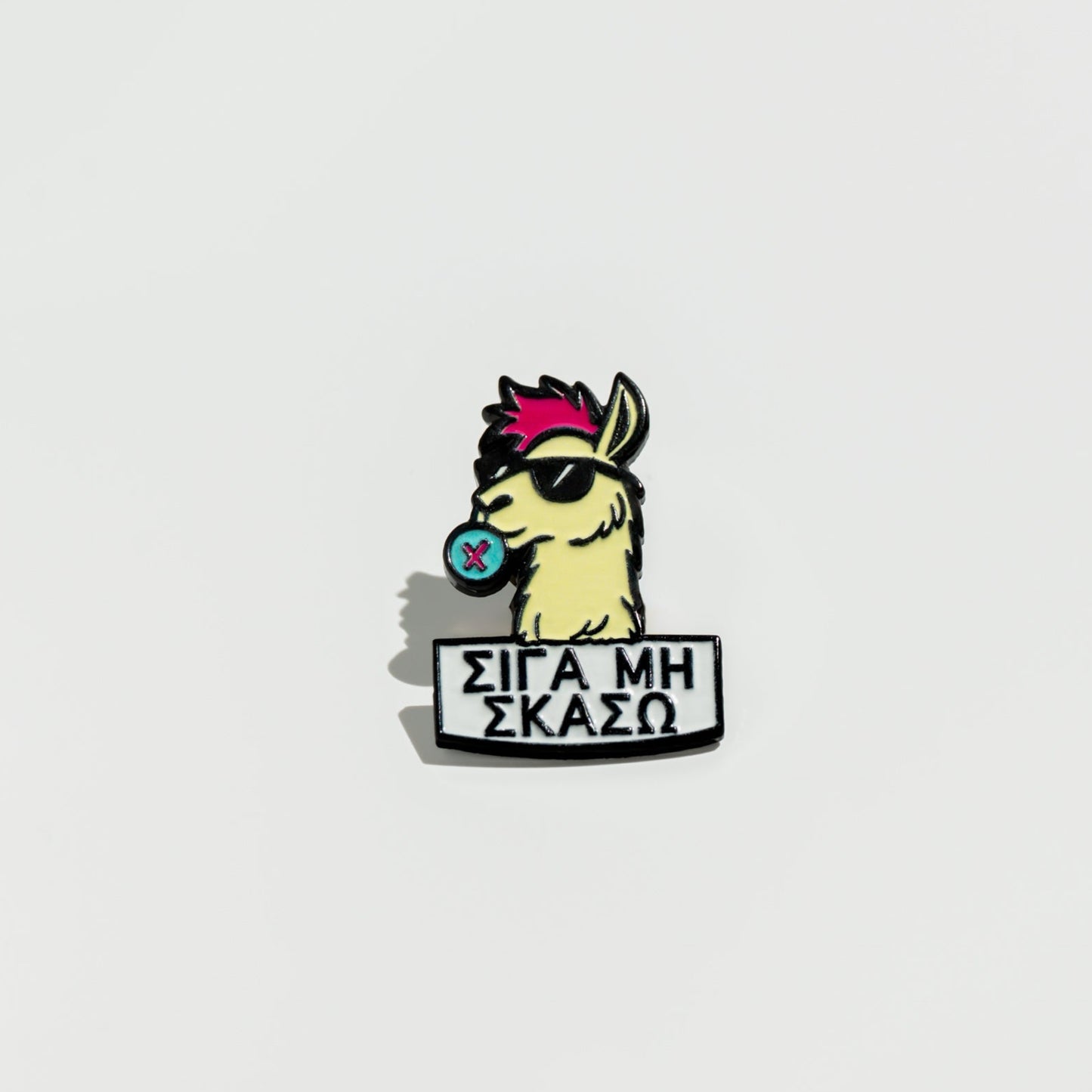 Enamel pin with a llama cartoon character and text on a white background