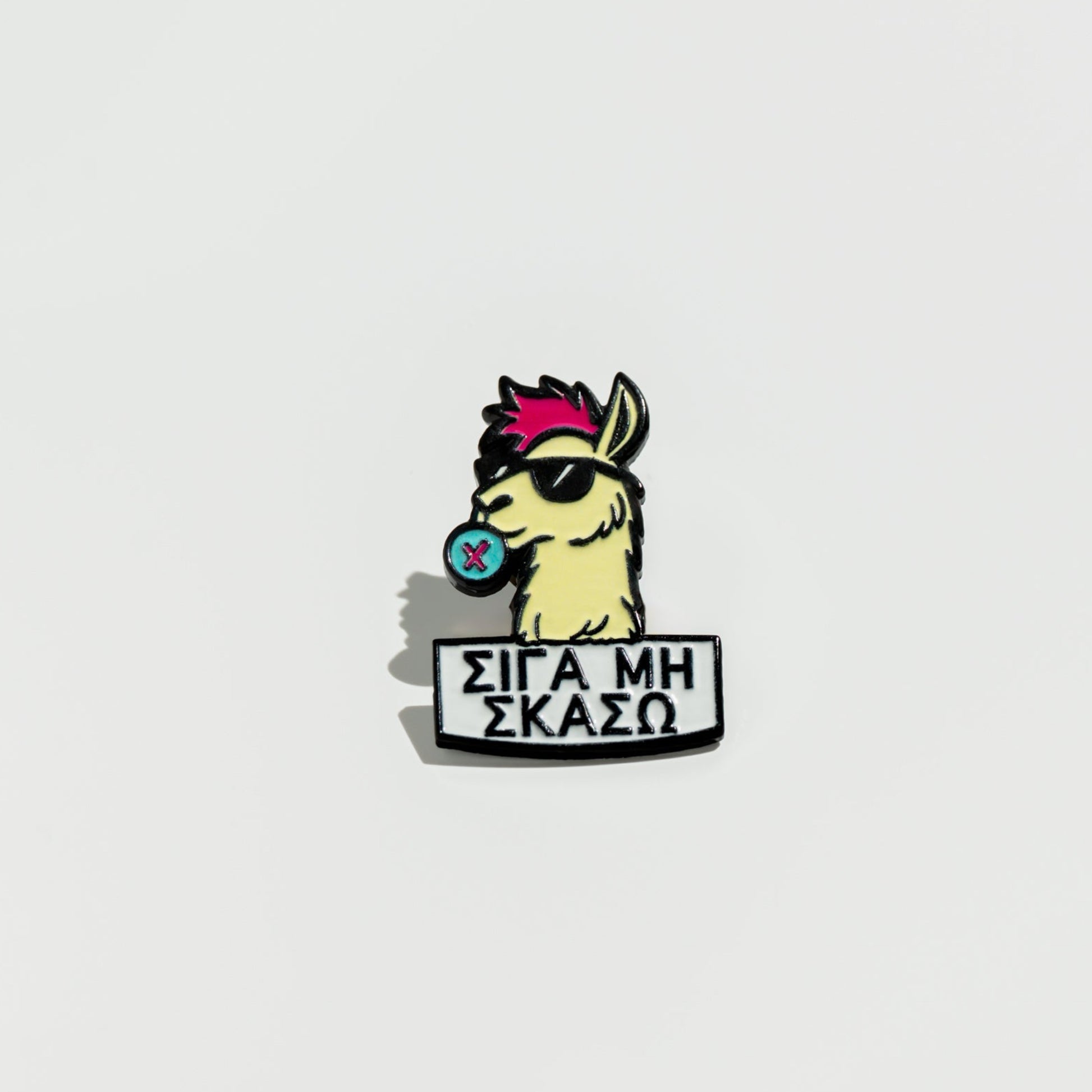 Enamel pin with a llama cartoon character and text on a white background
