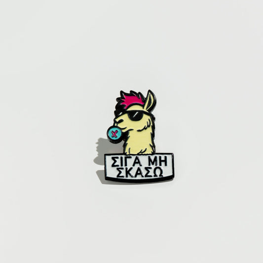 Enamel pin with a llama cartoon character and text on a white background